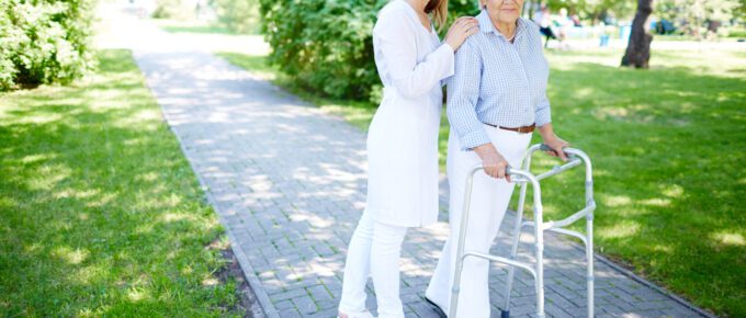A senior recovering from hip replacement surgery with her caregiver