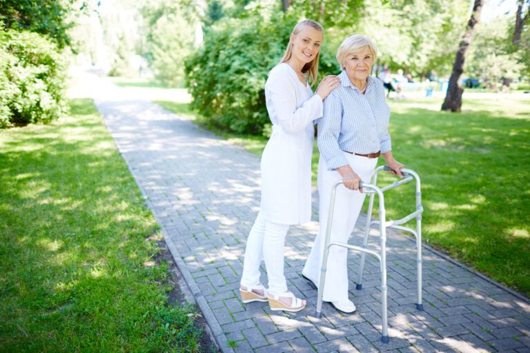 A senior recovering from hip replacement surgery with her caregiver
